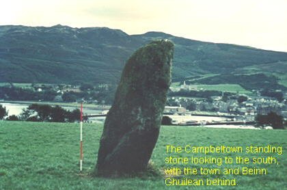    Standing stone looking south, with the town of Beinn Ghuilean behind